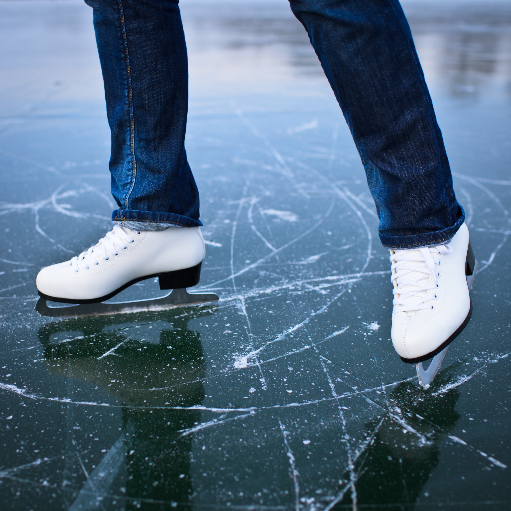 White figure skates finding balance on the ice
