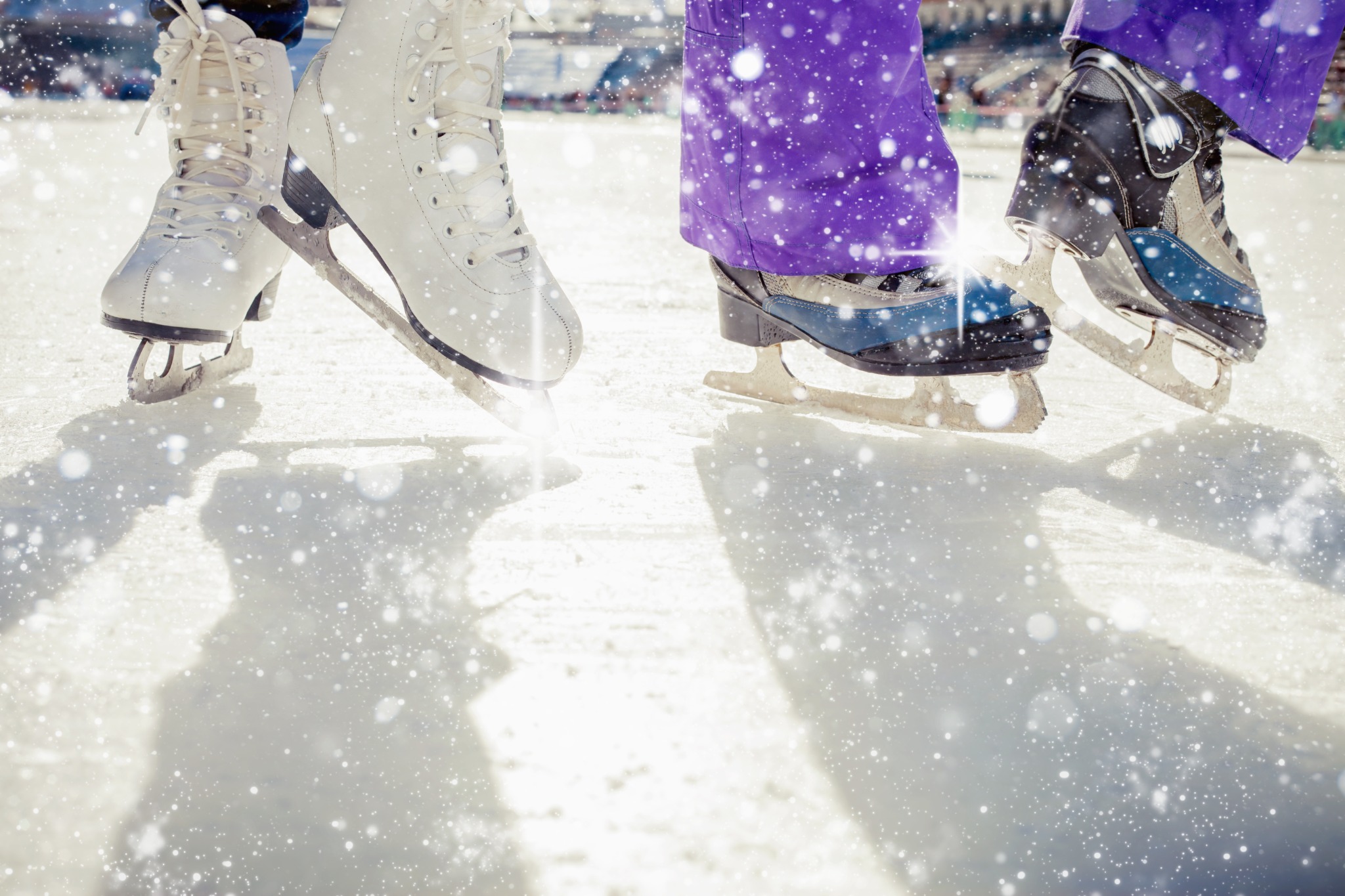 Skates on bright ice amid sparkling snowflakes